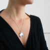 Statement minimalist pendant worn on a white woman.