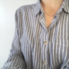 Artisan Custom Minimalist Silver CZ Apparel 2 Buttons are shown on the striped shirt on the woman.