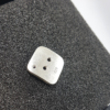 Artisan Custom Minimalist Silver Cubic Zirconia Apparel Button (back side) is placed on the black foam block.