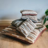 Stack of handwoven cushions from the Forest collection featuring Merino and blue-faced Leicester wools by Cassandra Sabo