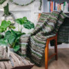 Handwoven 'Double Tendril' throw featuring Merino wool by Cassandra Sabo draped over a chair