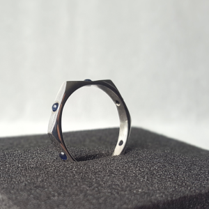 Statement ring in sterling silver and 6 sapphires stands on the black sponge.