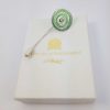 green aluminium pin displayed on gift box