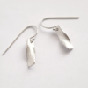Custom Contemporary Silver Dangle Earrings on a white surface.
