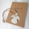 Handcrafted Silver Angel-Shaped Hanging Keepsake on a brown Andy Kashtan Jewellery paper tag.