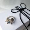 Artisan Silver Ring with London Blue Topaz on a white gift box.