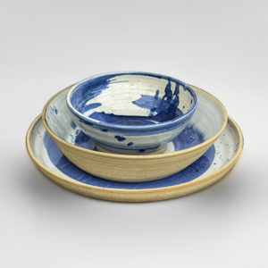 Blue and white dinner set with abstract brush marks and splashes, comprising of one large plate and two bowls